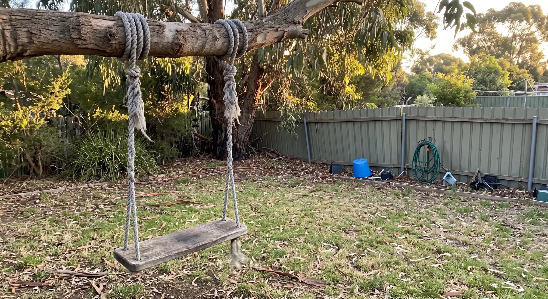 An old swing in a suburban backyard